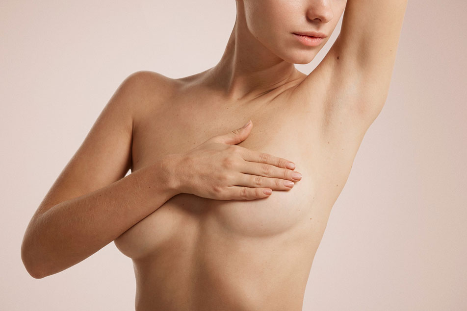 Woman covering her breasts with her hand