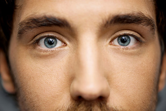 Closeup of man’s blue eyes