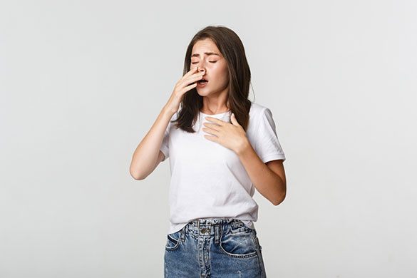 Woman sneezing from allergic reactions