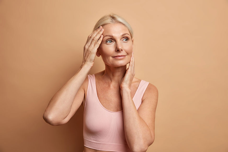 Aging woman admiring her youthful appearance