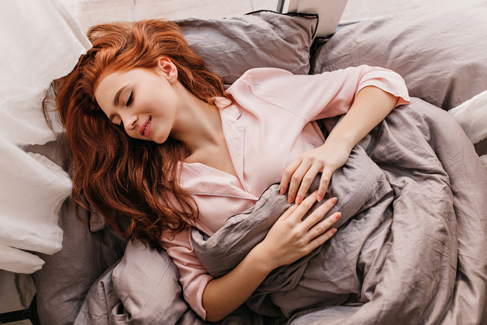 Woman sleeping on back elevated with pillows