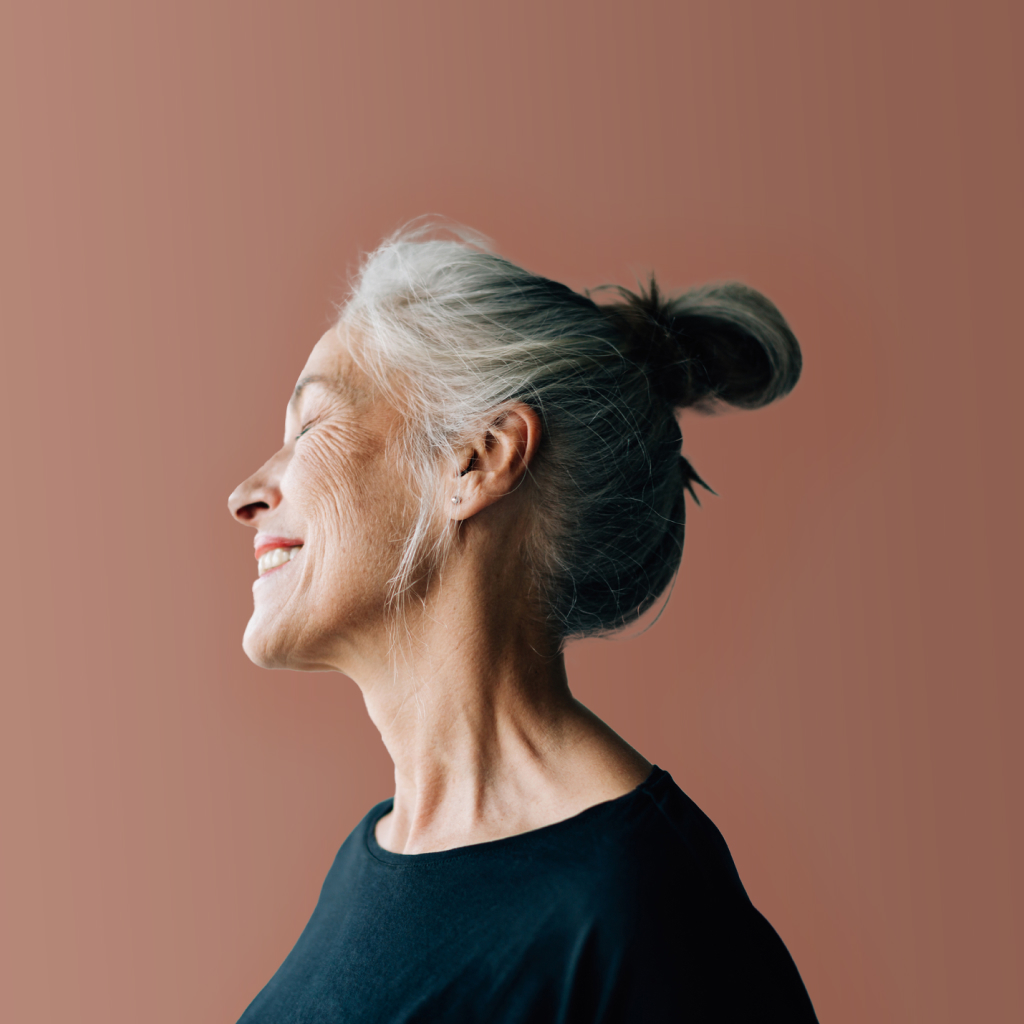 side profile of a grey haired women smiling