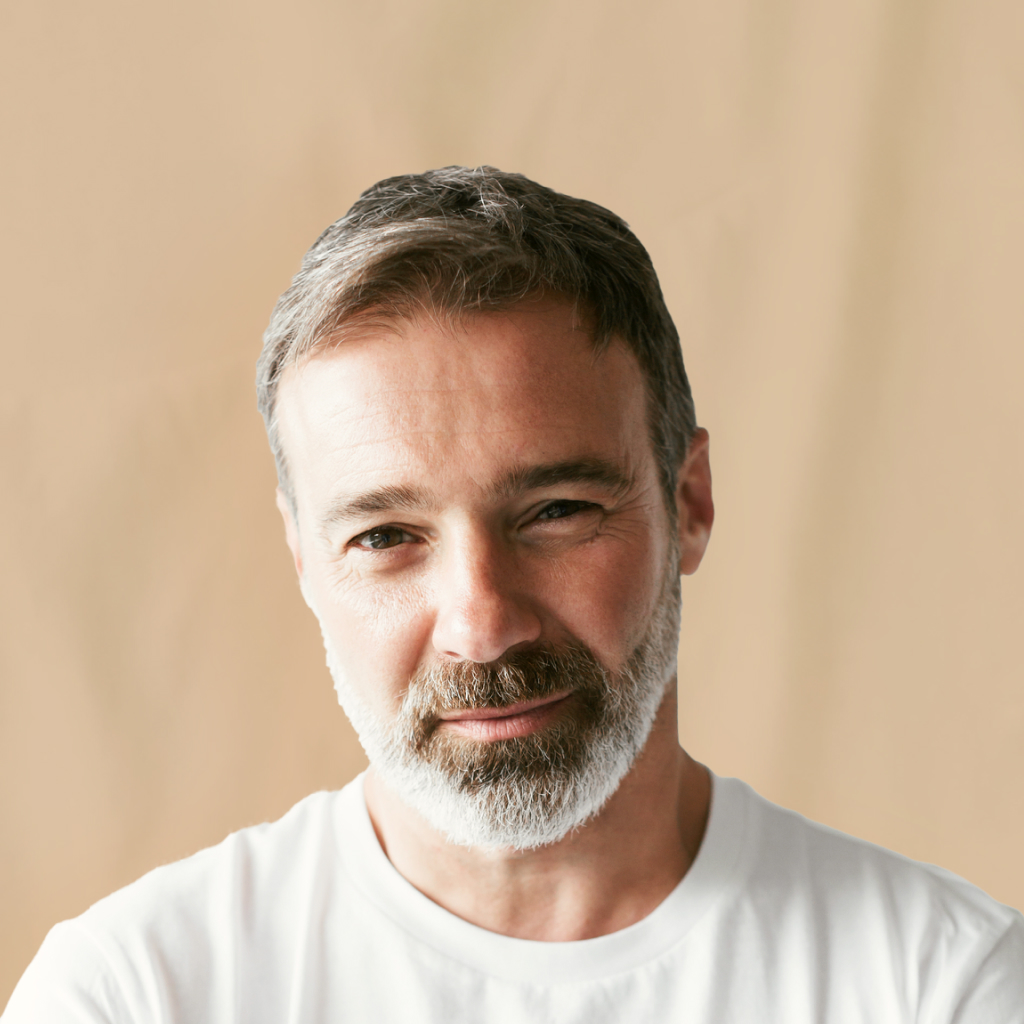 man with beard looking on beige background