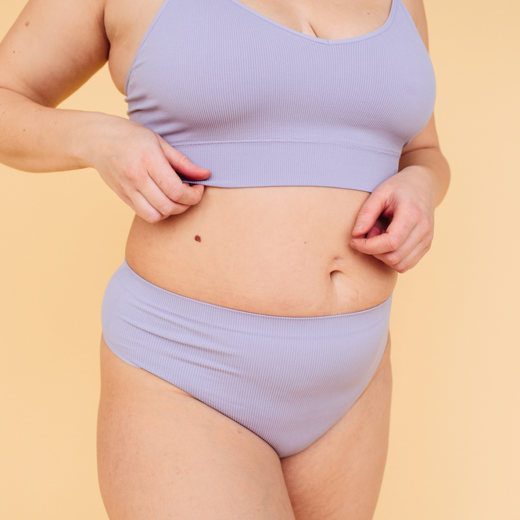 torso of feminine figure in lavender undergarments