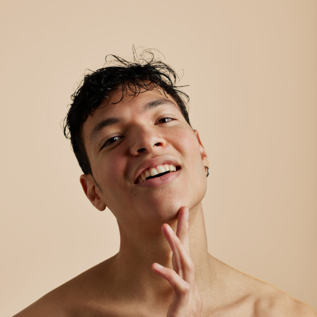 picture of a person touching jaw on a beige background