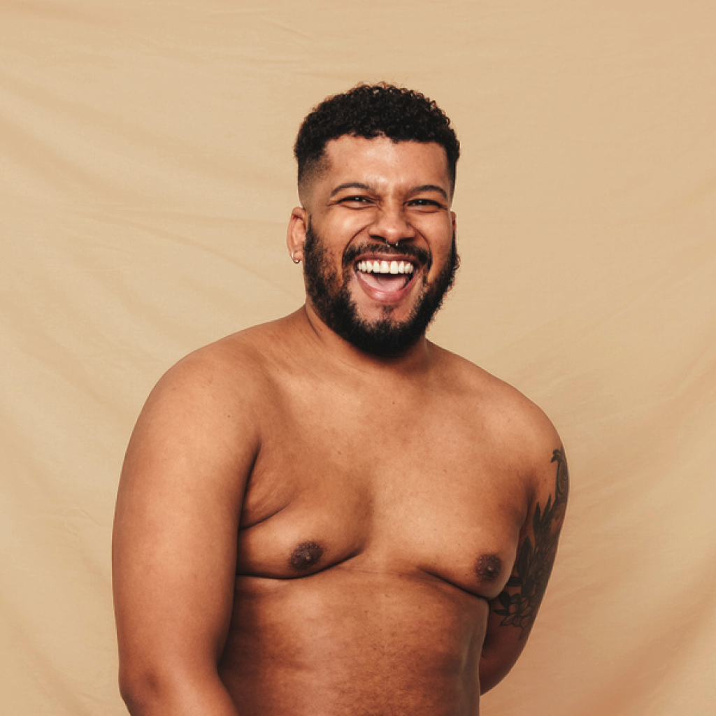 man on a cream background with exposed chest