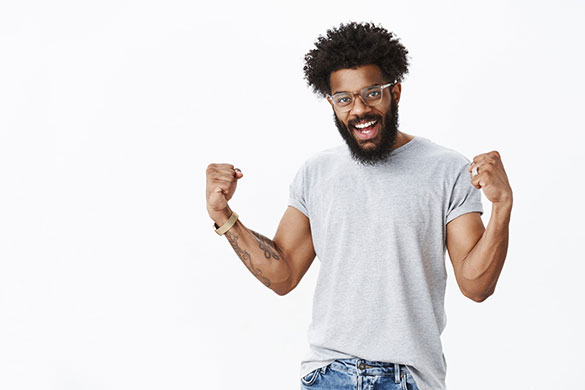 Happy man feeling confident while lifting his arms with optimism